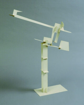 A white constructivist sculpture composed of several geometric parts.