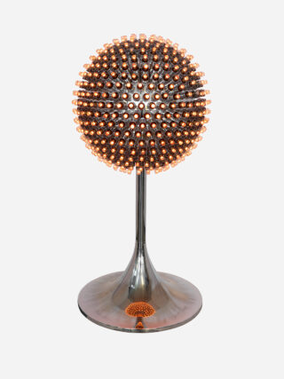 A glowing spherical object with many small light bulbs on a slender stand with a round base.