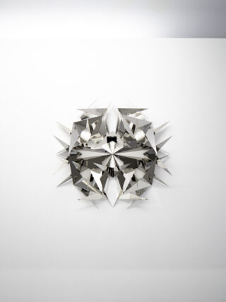 Symmetrical three-dymensional sculpture made of reflective metal with pointed star-shaped extensions.