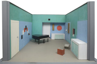 Room model of a studio, with a grand piano and abstract compositions on the walls.