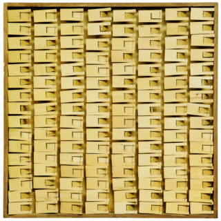 Numerous mousetraps arranged in a square pattern on a surface within a wooden frame.